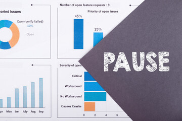 PAUSE written in a index paper on financial background. Business concept