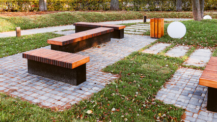 A recreation area in a city park in the form of a platform paved with paving slabs. There are...