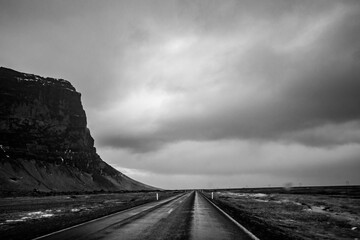 Driving in Iceland in Winter time, tourist trip around 1 Ring Road. Empty road stretching into the...