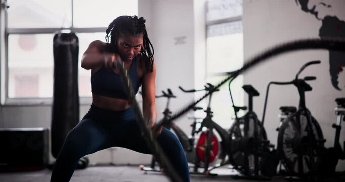 Black Woman, Fitness And Battle Rope At Gym For Workout, Exercise Or Muscle Endurance In Health Club. Indoor, Active African Female Person Or Athlete In Stamina, Cardio Or Intense Training For Sweat