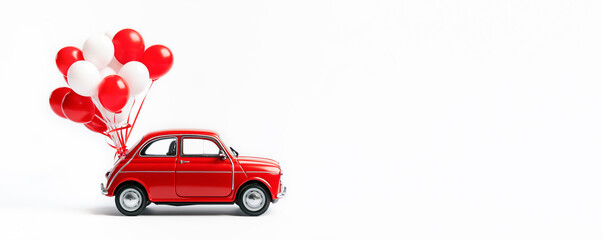 Red toy retro car with white and red balloons attached to it on a white background. Banner, card with empty space. Gift, congratulations