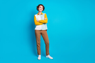 Full length photo of cheerful confident woman wear shirt arms crossed empty space isolated blue...