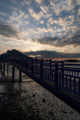 Fototapeta na wymiar View of the bridge at the seaside during sunset