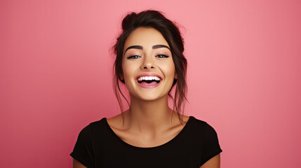 a beautiful blonde woman wearing black shirt expressing happiness emotion with her mouth laughing and big wide open eyes. isolated on pink background