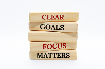 Clear goals and focus matters text on wooden blocks with white cover background