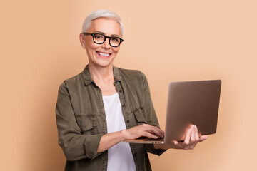 Photo of it specialist mature age woman strong middle level python developer using laptop linux...