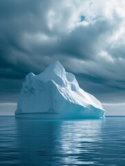 An iceberg stands majestically in the arctic ocean, surrounded by clouds and snow, as it slowly melts away, reminding us of the fragility of nature and the impact of climate change on our planet