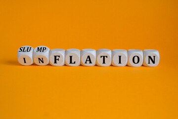 Inflation or slumpflation symbol. Concept words Inflation and Slumpflation on beautiful wooden cubes. Beautiful orange background. Business inflation slumpflation concept. Copy space.