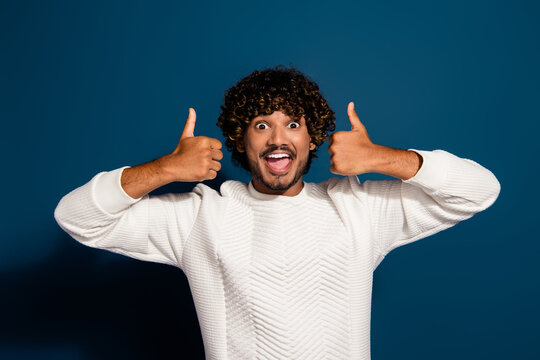 Portrait of overjoyed crazy promoter young student man showing his big respect double thumbs up isolated on dark blue color background