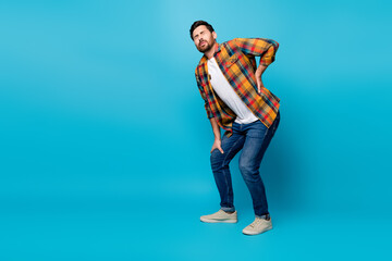 Full body photo of attractive young man touch lower back pain suffer dressed stylish checkered...