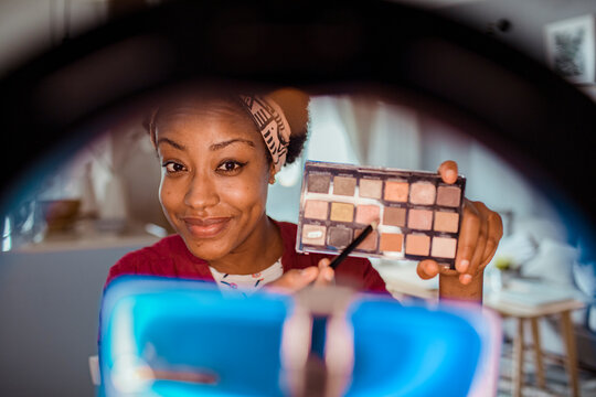 African American Woman Recording Makeup Tutorial with Ring Light at Home