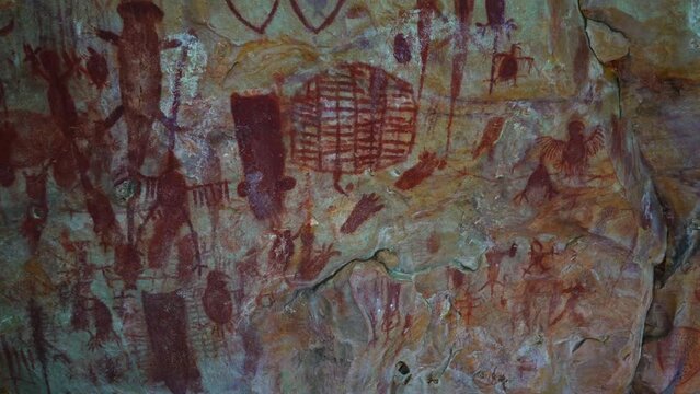 Prehistoric primitive cave art. Red painting of lizard on wall in Brazil