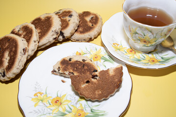 St davids  day  celebrations welsh  Flags  Welsh cake  Daffodils   Vintage  tea  party  and  teacup  on a yellow  back ground 