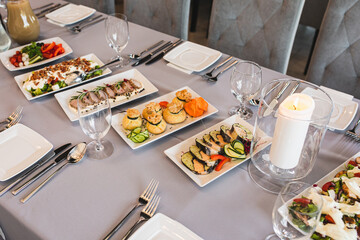 Festive table with various cold snacks standing in center. View from above. Enjoying taste.