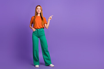 Full body length photo of student red hair lady stylish green pants and orange t shirt direct...