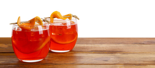 Aperol spritz cocktail and orange slices in glasses on wooden table against white background