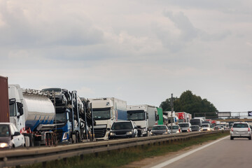 Queue of Trucks on Ukraine-Poland Border traffic jam at Sunset During Protest Roadblock. Business agricultural Logistics blockade action. Cargo lorry semi-trailers stuck - obrazy, fototapety, plakaty