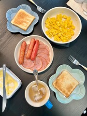 breakfast with eggs, sausages, ham and toast