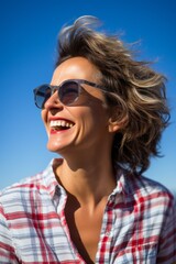 Portrait of a happy young woman laughing with the wind in her hair
