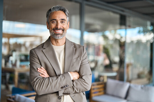 Happy middle aged business man entrepreneur looking at camera outdoors. Smiling confident mature businessman professional executive, successful lawyer wearing suit standing arms crossed, portrait. - Powered by Adobe