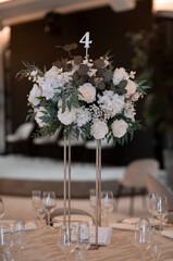 Luxury wedding table setting with flower centerpieces and candles