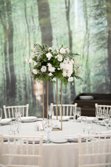 Luxury wedding table setting with flower centerpieces and candles