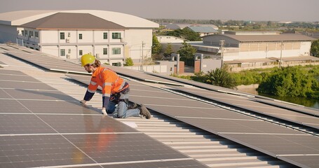 A technician engineer in a high-visibility vest and helmet installs solar panels on a roof, showcasing renewable energy solutions in an urban