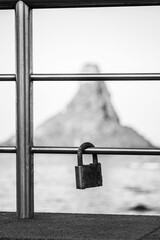 a padlock left by a couple on the handrail of the Aci Trezza seafront