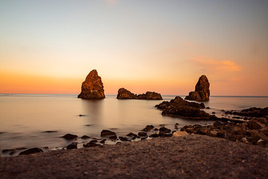 a fantastic vintage sunset in the company of the Cyclops Islands in Aci Trezza