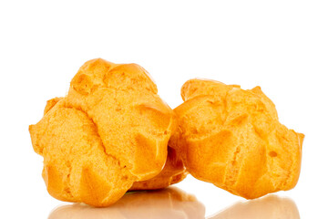 Three delicious eclairs, macro, isolated on white background.