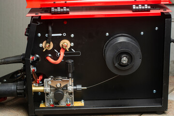 Close-up of the feed mechanism of a semi-automatic welding machine MIG MAG