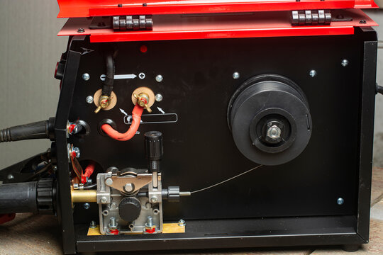 Close-up of the feed mechanism of a semi-automatic welding machine MIG MAG