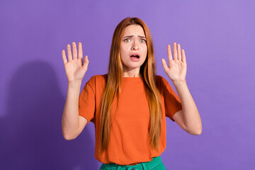 Close up photo of amazed young red hair girl raised arms up when horrified looking at scary monster...
