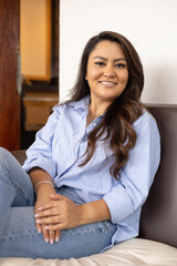 Obraz premium latin woman wearing shirt, jeans and long hair, relaxed lifestyle, portrait of resting person sitting on chair, day