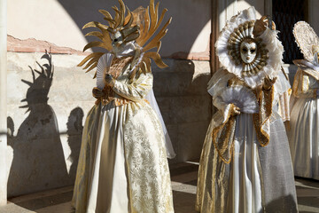 Venice, Italy - February 2024 - carnival masks are photographed with tourists in San Marco square