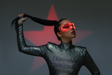 Disco girl in neon glasses and red star at background.