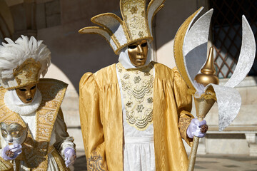 Venice, Italy - February 2024 - carnival masks are photographed with tourists in San Marco square