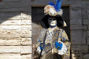 Venice, Italy - February 2024 - carnival masks are photographed with tourists in San Marco square