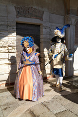 Fototapeta na wymiar Venice, Italy - February 2024 - carnival masks are photographed with tourists in San Marco square