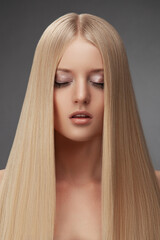 Portrait of a blonde girl with gorgeous long straight hair. - 738249884