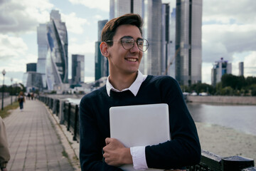 Good grades. A young attractive student is happy about going to college. A guy is walking in the city.