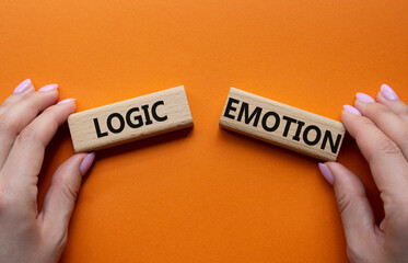 Logic or Emotion symbol. Concept word Logic or Emotion on wooden blocks. Businessman hand....
