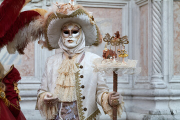 Obraz premium Venice, Italy - February 2024 - carnival masks are photographed with tourists in San Marco square