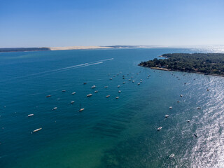 Aerial view on Arcachon Bay with many fisherman's boats and oysters farms near Le Phare du Cap...