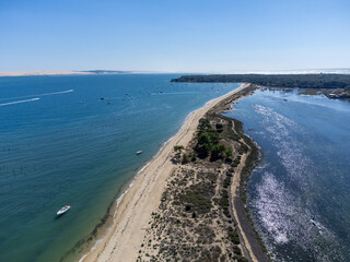 Aerial view on Arcachon Bay with many fisherman's boats and oysters farms near Le Phare du Cap...