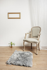 an unvarnished light wooden armchair with a gray upholstered seat, a gray rug with white curtains...