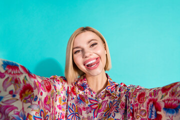 Photo of coquette lovely woman with bob hairstyle dressed print blouse doing selfie licking teeth...