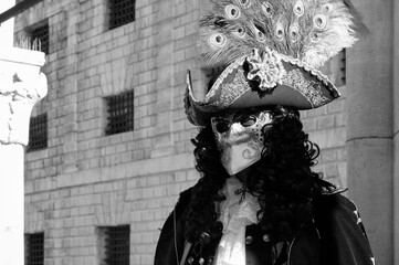 Venice, Italy - February 2024 - carnival masks are photographed with tourists in San Marco square