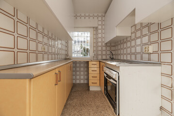 Fototapeta premium Old kitchen that needs a complete renovation of furniture and tiles