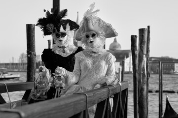 Venice, Italy - February 2024 - carnival masks are photographed with tourists in San Marco square